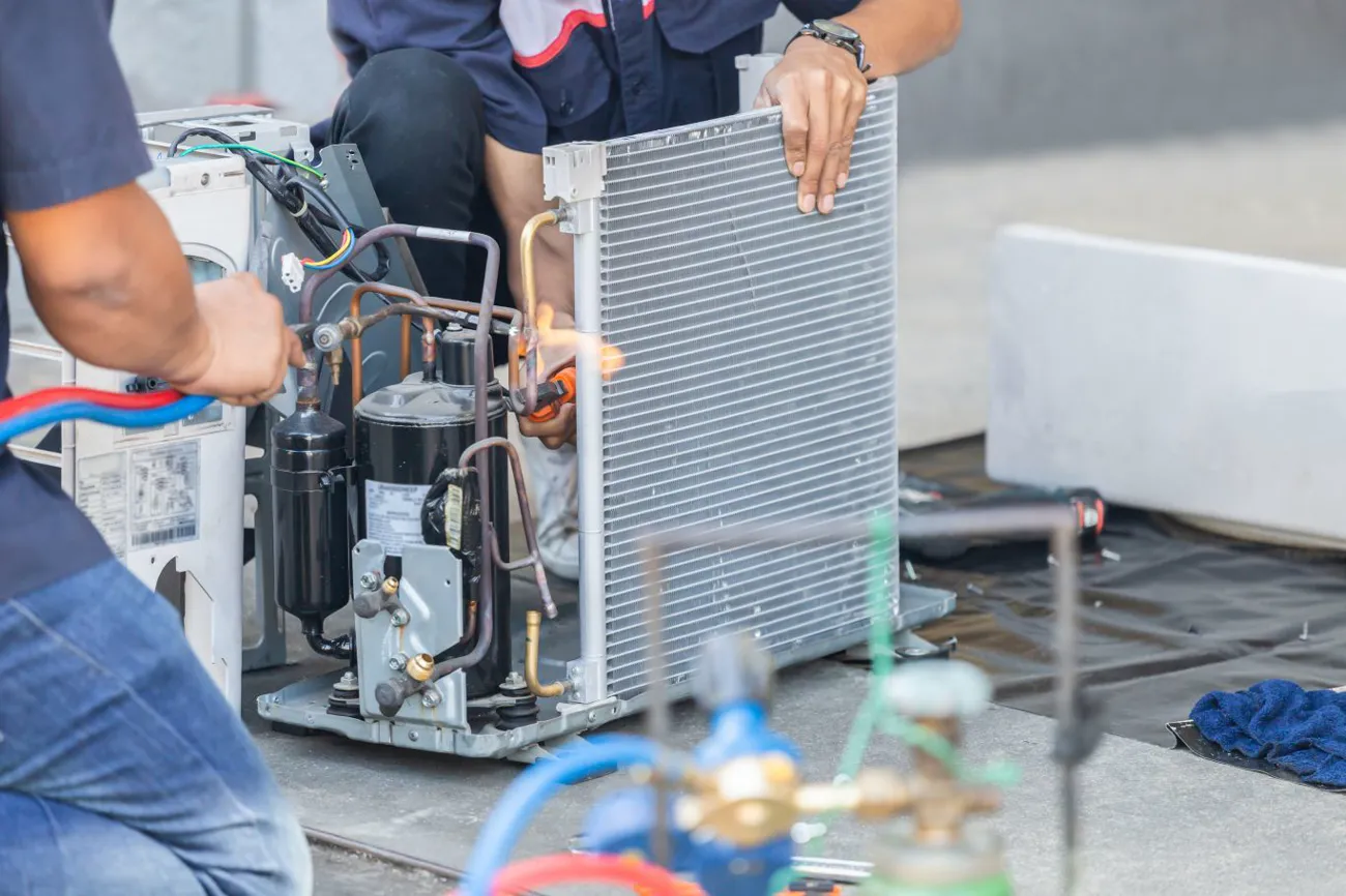 Aeromark technician servicing an outdoor condensing unit